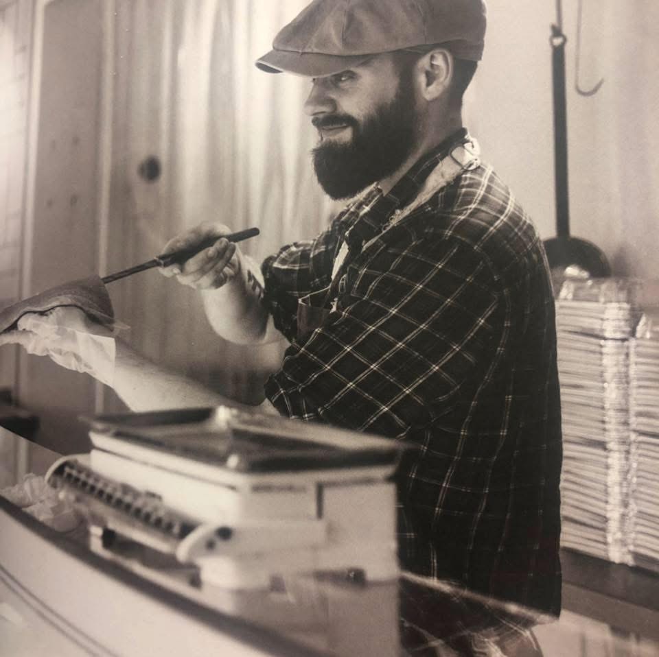 Gulli welcoming locals and tourists while working in a butcher shop in Iceland